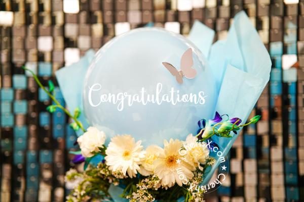 The silver butterfly is the cream point in the bouquet