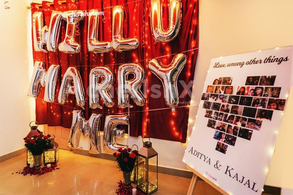 Romantic Set up with CherishX's Will your Marry me balloon decor and Guitarist.