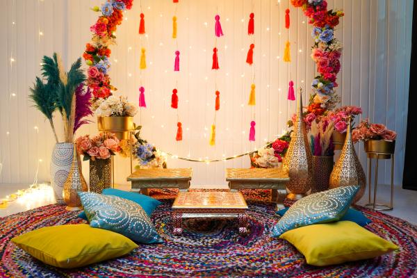 The stunning ring backdrop with lights and flower bunches is perfect for pictures of the Mehndi ceremony