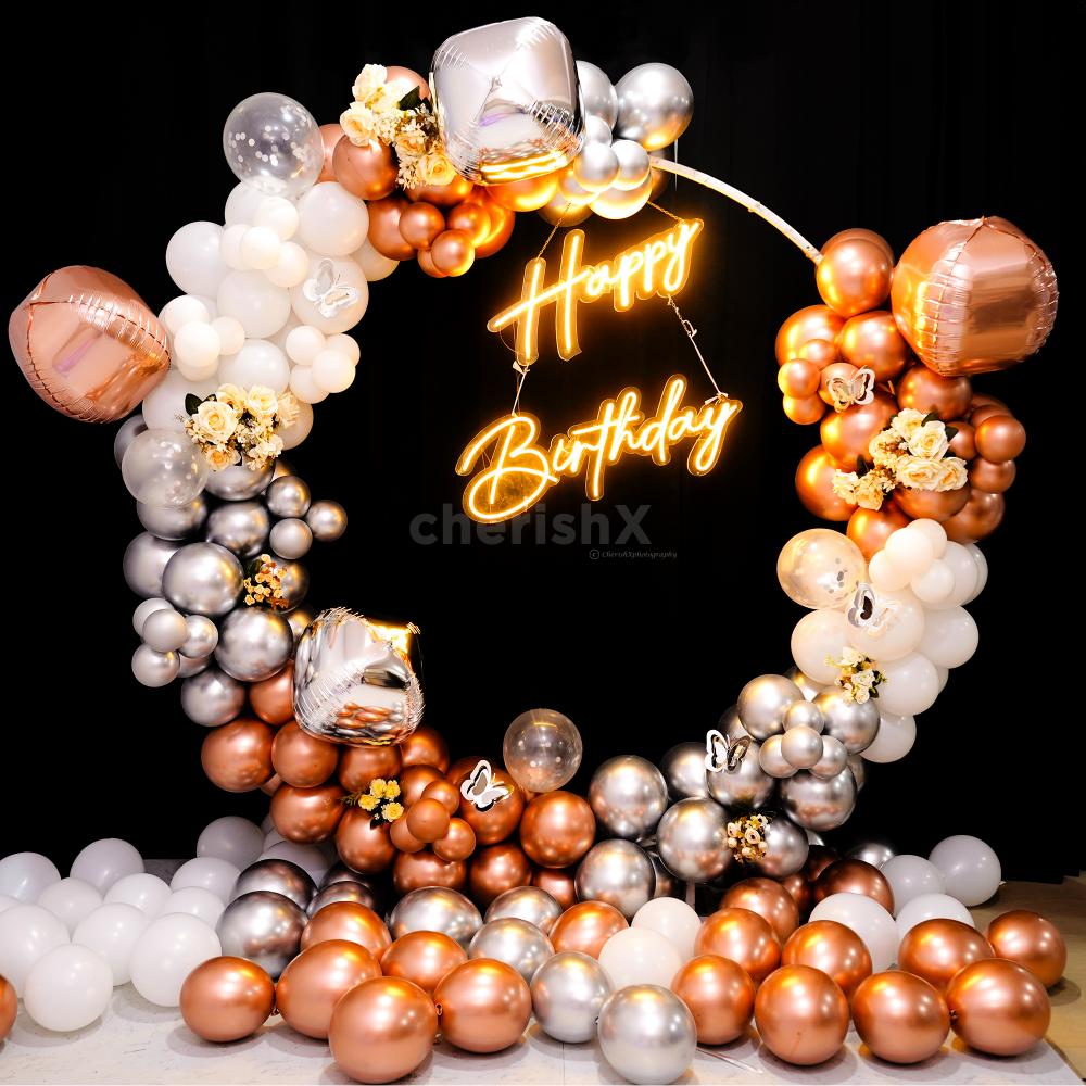 This dreamy metallic ring backdrop is adorned with silver and rose gold balloos