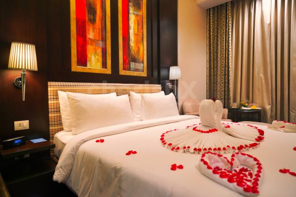 Rose petals on the bed will add a romantic flair between the two.
