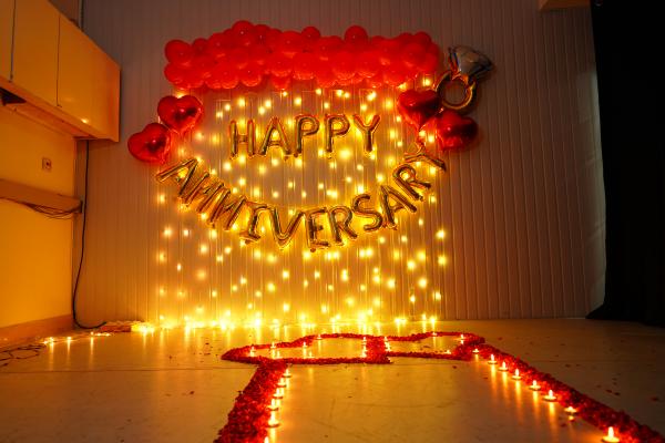 Vibrant red balloons symbolize the intensity of your love, while tea light candles create an intimate ambience, casting a warm glow on your special moments.