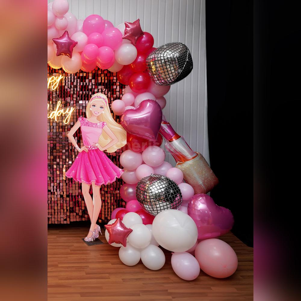 Barbie and car cutouts against a shimmering backdrop add more glam to the decor.