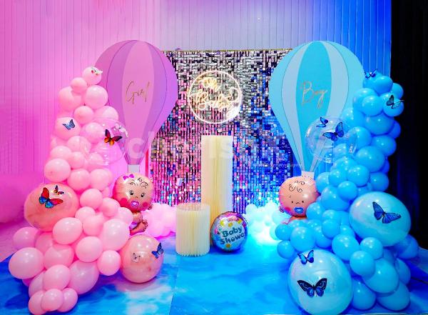 Experience the blissful ambience created by a harmonious mix of pink and blue bubble balloons, symbolizing the arrival of your precious little one.