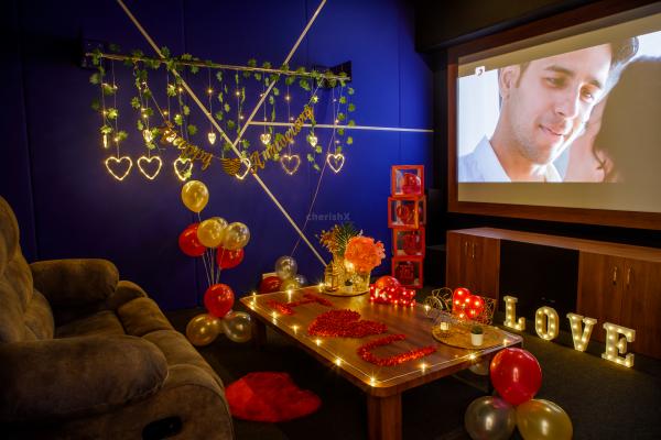 An enchanting movie night awaits, surrounded by flower petals and candlelight.