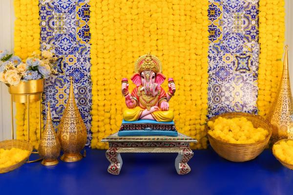 Immerse in the serenity of a blue Textured Flex adorned with artificial yellow garlands, as our decoration sets the space for a spiritually charged celebration.